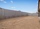 Large, empty backyard enclosed by a tall block wall at 4323 W Josephine St, San Tan Valley, AZ 85144