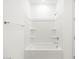 Bathroom showcasing white tub, shower, towel rack, and shower shelves at 4323 W Josephine St, San Tan Valley, AZ 85144