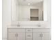 Double sink vanity with white cabinets, white countertops, and a large mirror at 4323 W Josephine St, San Tan Valley, AZ 85144