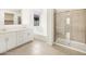 Bright bathroom featuring a double sink vanity, shower, and separate soaking tub for relaxation at 4323 W Josephine St, San Tan Valley, AZ 85144
