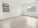 Bright and spacious bedroom with tile flooring and two windows at 4323 W Josephine St, San Tan Valley, AZ 85144