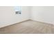 Clean, carpeted bedroom with a bright window providing natural light at 4323 W Josephine St, San Tan Valley, AZ 85144