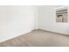 Empty bedroom with neutral carpet, a window, and white walls at 4323 W Josephine St, San Tan Valley, AZ 85144