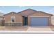 Beautiful single-story home with a two-car garage, stone accents, and desert landscaping at 4323 W Josephine St, San Tan Valley, AZ 85144