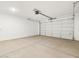 Spacious two car garage with concrete floor and white garage door at 4323 W Josephine St, San Tan Valley, AZ 85144