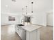 Open-concept kitchen featuring a large island with stainless steel appliances and views of the living area at 4323 W Josephine St, San Tan Valley, AZ 85144