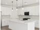 Kitchen features white cabinetry, modern backsplash, stainless steel appliances, and quartz countertops at 4323 W Josephine St, San Tan Valley, AZ 85144
