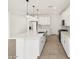 Bright kitchen featuring white cabinets, stainless steel appliances, and a large island with pendant lighting at 4323 W Josephine St, San Tan Valley, AZ 85144