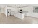 Modern kitchen boasts white cabinets, a central island, stainless steel appliances, and stylish pendant lighting at 4323 W Josephine St, San Tan Valley, AZ 85144