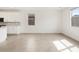 Bright living space featuring a modern kitchen with white cabinets and stainless steel appliances at 4323 W Josephine St, San Tan Valley, AZ 85144