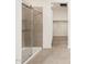 Modern shower with tan tiling and a glass enclosure, perfect for a stylish bathroom at 4323 W Josephine St, San Tan Valley, AZ 85144