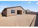 New home backyard with dirt landscaping, block wall, and covered patio at 4919 W Hunter Trl, San Tan Valley, AZ 85144