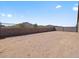 Expansive dirt backyard enclosed with block wall, providing privacy and a blank canvas for outdoor living at 4919 W Hunter Trl, San Tan Valley, AZ 85144