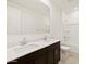 Bright bathroom featuring double sinks, dark wood cabinets, and a shower-tub combination at 4919 W Hunter Trl, San Tan Valley, AZ 85144