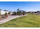 Serene community park featuring a picnic area, benches, and lush green space, perfect for Gathering gatherings at 4919 W Hunter Trl, San Tan Valley, AZ 85144