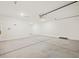 A spacious garage featuring smooth concrete flooring and an automatic door opener at 4919 W Hunter Trl, San Tan Valley, AZ 85144