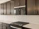 Modern kitchen details including built in microwave, gas cooktop, and sleek cabinetry at 4919 W Hunter Trl, San Tan Valley, AZ 85144