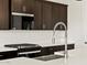 Close-up of a kitchen with stainless steel appliances, quartz countertops, and subway tile at 4919 W Hunter Trl, San Tan Valley, AZ 85144