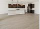 Open-concept kitchen with a large island, dark cabinets, and modern pendant lighting at 4919 W Hunter Trl, San Tan Valley, AZ 85144