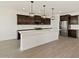 Bright kitchen featuring a large island, stainless steel refrigerator, and modern cabinetry at 4919 W Hunter Trl, San Tan Valley, AZ 85144