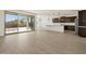 Open-concept living area with tile flooring, leading to outdoor patio, and a view of the modern kitchen at 4919 W Hunter Trl, San Tan Valley, AZ 85144