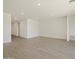 Spacious living room with light tile floors, recessed lighting, and neutral color palette at 4919 W Hunter Trl, San Tan Valley, AZ 85144