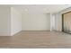 Bright and airy living room with tile flooring and access to an outdoor patio through sliding glass doors at 4919 W Hunter Trl, San Tan Valley, AZ 85144