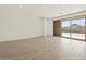 Living room with tile flooring, sliding glass doors to patio, and views of the surrounding landscape at 4919 W Hunter Trl, San Tan Valley, AZ 85144