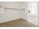 Bright walk-in closet with access to a modern bathroom featuring a luxurious bathtub at 4919 W Hunter Trl, San Tan Valley, AZ 85144