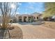 Beautiful desert home with a circular driveway and mature landscaping at 10801 E Happy Valley Rd # 27, Scottsdale, AZ 85255