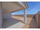 Covered patio overlooking a spacious backyard with block wall fencing at 25137 N 171St Ave, Surprise, AZ 85387