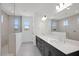 Bathroom featuring a double vanity, tiled shower with glass doors, and modern fixtures at 25137 N 171St Ave, Surprise, AZ 85387