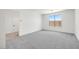 Bedroom with gray carpeting, window, white walls, and white trim at 25137 N 171St Ave, Surprise, AZ 85387