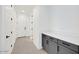 Hallway featuring a gray cabinet, white trim, and several doors at 25137 N 171St Ave, Surprise, AZ 85387
