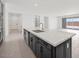 Modern kitchen with a large island, stainless steel appliances, and white countertops at 25137 N 171St Ave, Surprise, AZ 85387