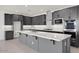 Modern kitchen with gray cabinets, a spacious island, and stainless steel appliances at 25137 N 171St Ave, Surprise, AZ 85387