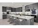 Stylish kitchen featuring gray cabinets, stainless steel appliances, and a central island with bar seating at 25137 N 171St Ave, Surprise, AZ 85387