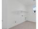 Laundry room with white shelving, tile flooring, and hookups for a washer and dryer at 25137 N 171St Ave, Surprise, AZ 85387