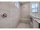Walk-in shower features gray tiling, a built-in bench, and a glass enclosure at 25137 N 171St Ave, Surprise, AZ 85387
