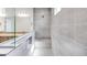 Stylish bathroom featuring gray tiled shower with glass door and built-in seat at 25149 N 171St Ave, Surprise, AZ 85387