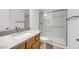 Bathroom with modern vanity, sink, and walk-in shower with glass door at 25149 N 171St Ave, Surprise, AZ 85387