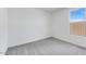 Bright bedroom with neutral carpet, white walls, and a large window at 25149 N 171St Ave, Surprise, AZ 85387