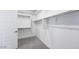 Walk-in closet with multiple shelves, rods, and neutral carpet at 25149 N 171St Ave, Surprise, AZ 85387