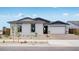 Charming single-story home with a well-manicured front yard, large windows, and a two-car garage at 25149 N 171St Ave, Surprise, AZ 85387