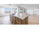 Bright kitchen with a large island, stainless steel appliances, and open access to living areas at 25149 N 171St Ave, Surprise, AZ 85387