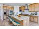 Beautiful kitchen featuring a large island, breakfast bar seating, stainless steel appliances, and modern finishes at 25149 N 171St Ave, Surprise, AZ 85387