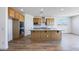 Spacious kitchen featuring an island, stainless steel appliances, and wood-look tile flooring at 25149 N 171St Ave, Surprise, AZ 85387