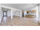 Open layout with wood-look flooring, kitchen with island, and natural light at 25149 N 171St Ave, Surprise, AZ 85387