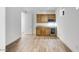Bright and spacious room with custom cabinets, a built-in bar, and wood-look tile flooring at 25149 N 171St Ave, Surprise, AZ 85387