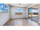 Bright room featuring wood-look floors, natural light, and sliding glass doors at 25149 N 171St Ave, Surprise, AZ 85387